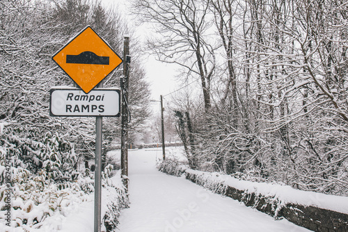 Принти на полотні Irish village during Storm Emma, also known as the Beast from the East, which hit Ireland in the beginning of March: ramps traffic sign