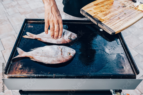 Food: Fish, sea bream, being grilled on a plancha photo