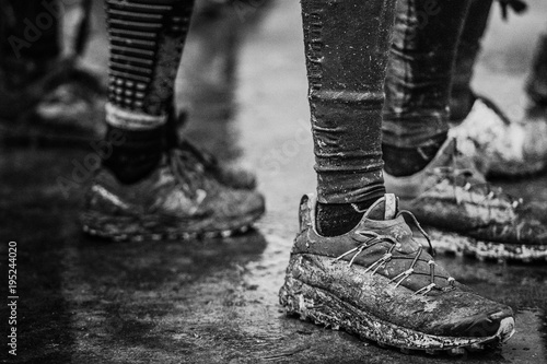 Black and white muddy dirty shoes after trail running run