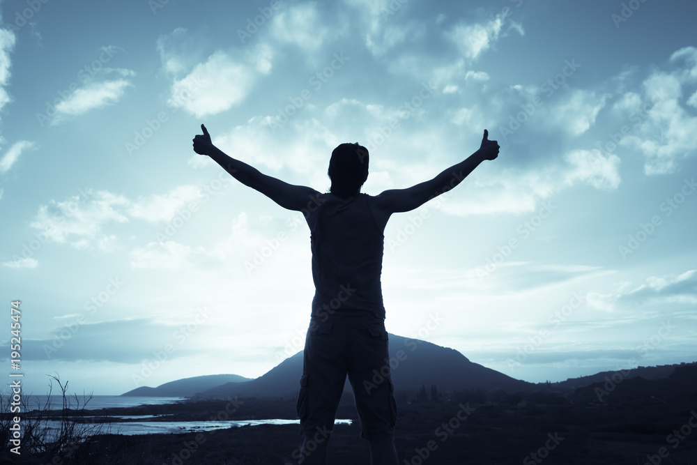 Positive feelings. Man standing on a mountain feeling happy, and free. Thumbs up! Positive feelings. Man standing on a mountain feeling happy, and free. Thumbs up!