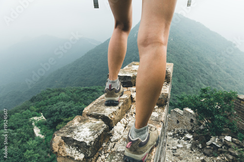 successful woman hiker enjoy the view on the top of great wall