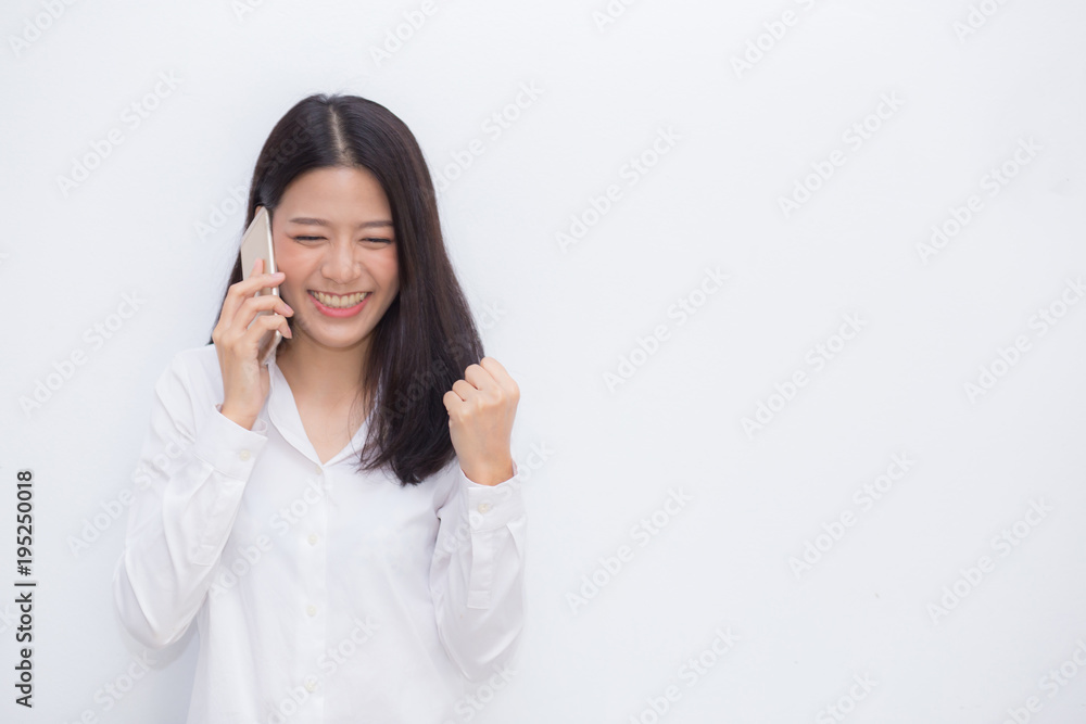 Beautiful asian young businesswoman excited and glad of success taking mobile phone on cement background, career freelance business concept. Beautiful asian young businesswoman excited and glad of success taking mobile phone on cement background, career freelance business concept.