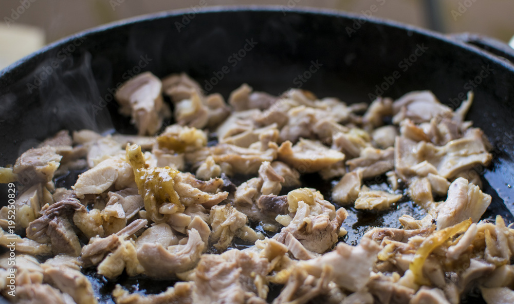 Preparation of roasted chopped meat in a frying pan.