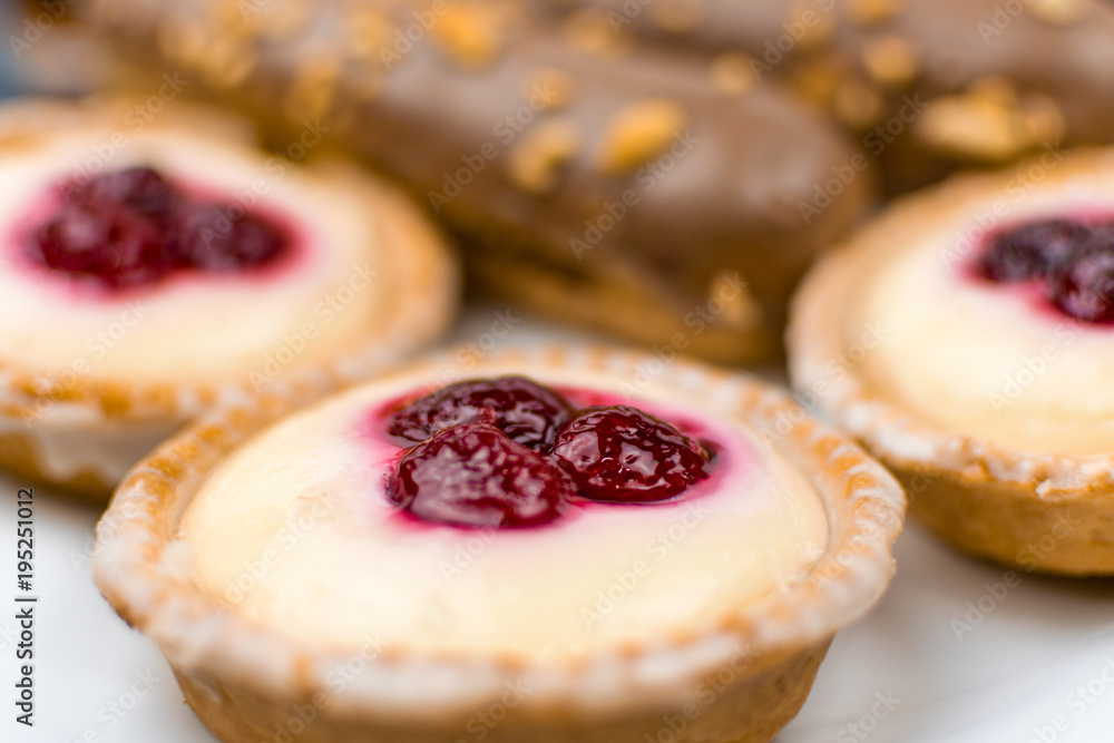 A set of different cakes on a white plate. A set of different cakes on a white plate.