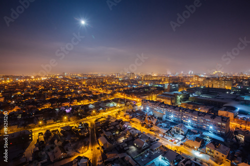 Night Voronezh aerial cityscape from rooftop. Residential area. Moon above city
