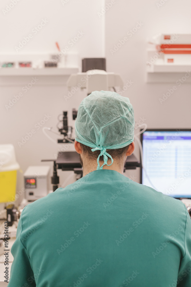 Back view of biologist working in a Professional Laboratory Back view of biologist working in a Professional Laboratory
