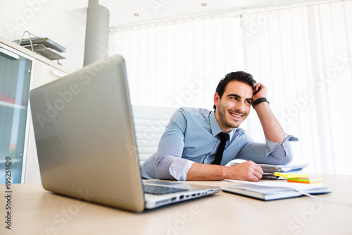 Lonley tiresome businessman spending time at work