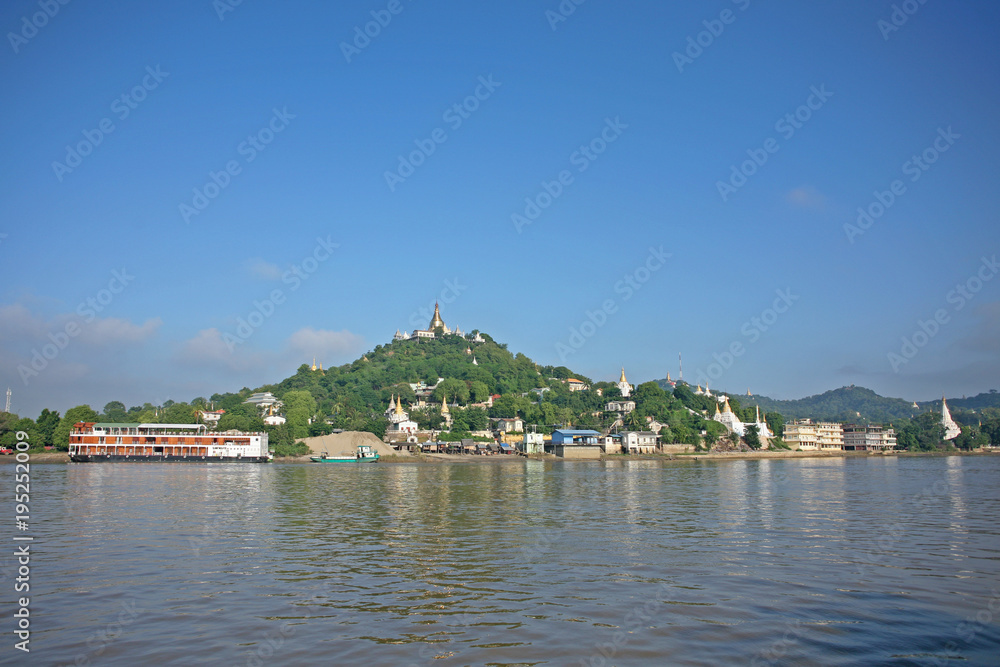 Pagodas gleam on the serene riverbanks of the Irrawaddy in Burma