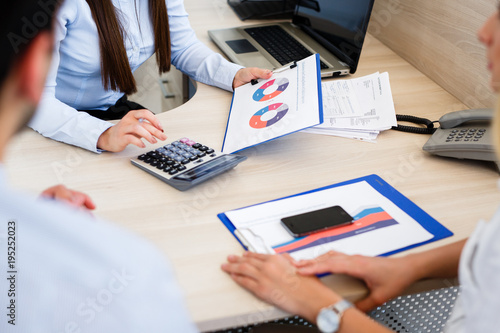 Young bankers analysing financial report