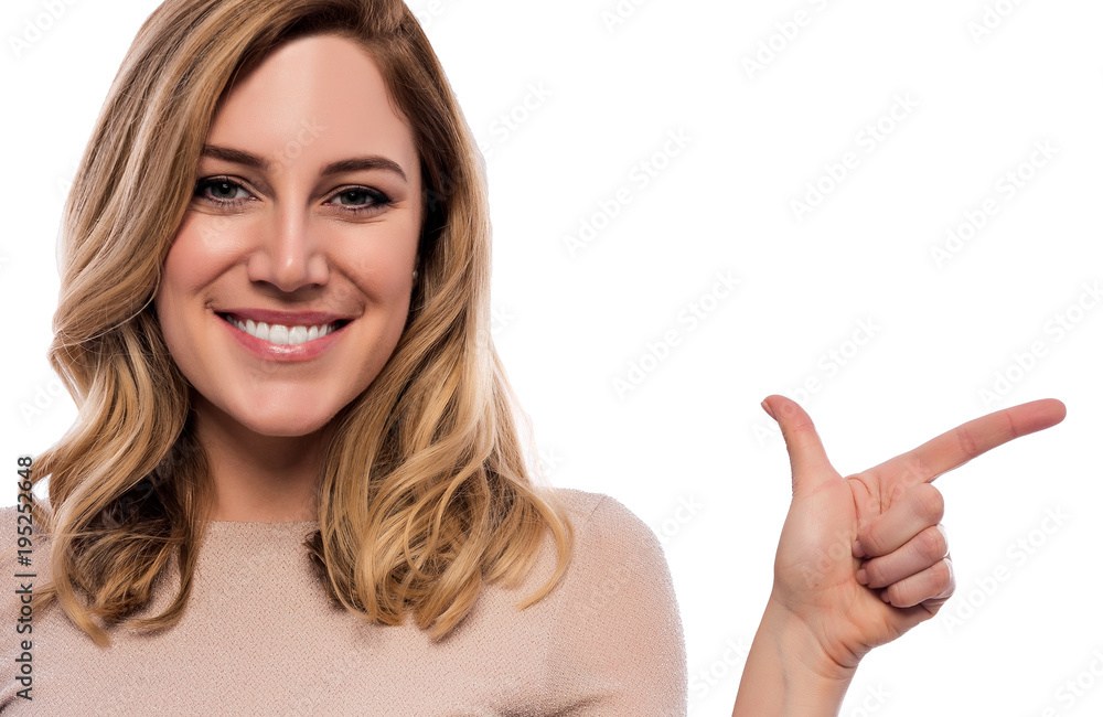 Attractive blonde points a finger at the empty space. Attractive blonde points a finger at the empty space.