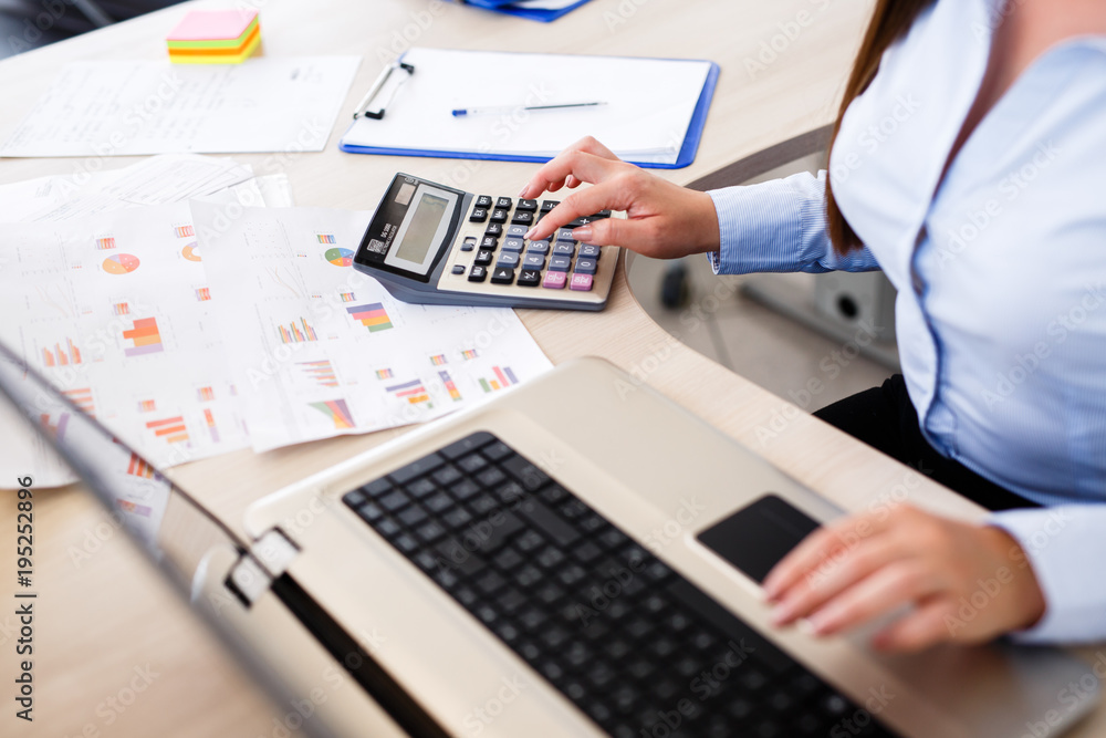 Young female economist calculate on Young female economist calculate on
