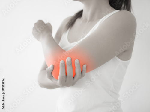 Close up woman having pain in injured elbow. Health care and arm pain concept.