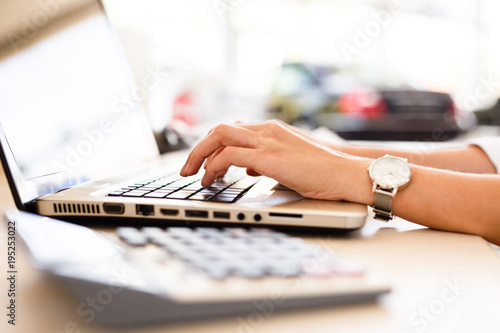 Car shop dealer working on financial documents