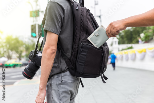 pickpocket stealing wallet from tourist photo