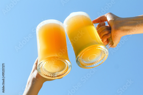 Canvas Print People clink beer.