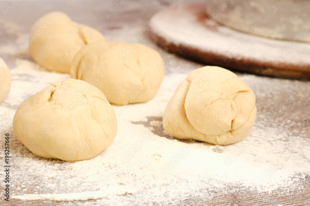 Unleavened dough for tortillas with flour and hand on kitchen table. Cooking burrito. Unleavened dough for tortillas with flour and hand on kitchen table. Cooking burrito.