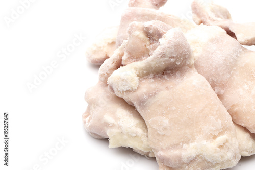 Raw Frozen Chicken Thighs on a White Background