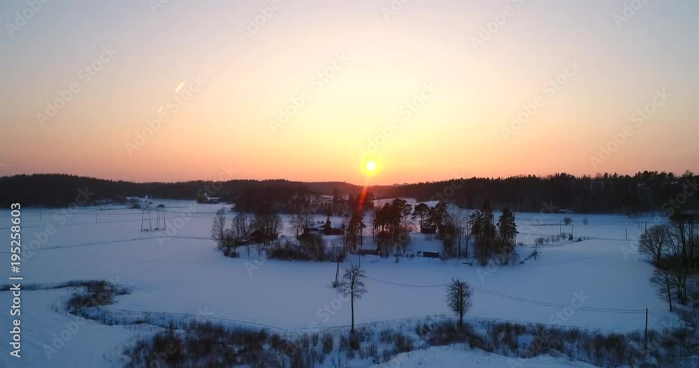Ice cold winter sunset, Cinema 4k aerial rising view of a dawn above the countryside, on a freezing cold winter evening, in Sipoonkorpi national park, Uusimaa, Finland Ice cold winter sunset, Cinema 4k aerial rising view of a dawn above the countryside, on a freezing cold winter evening, in Sipoonkorpi national park, Uusimaa, Finland