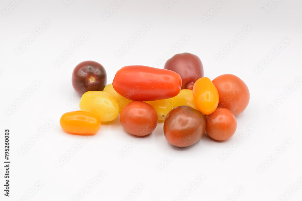 Tiny grape tomatoes in red, orange, yellow, and purple. Tiny grape tomatoes in red, orange, yellow, and purple.