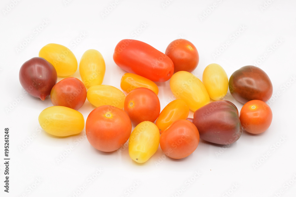 Tiny grape tomatoes in red, orange, yellow, and purple. Tiny grape tomatoes in red, orange, yellow, and purple.