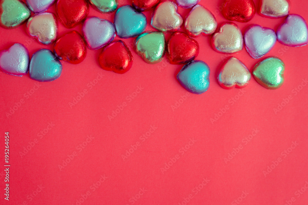 Obraz premium Red background with multicolored heart rests in the concept of Valentine's Day.