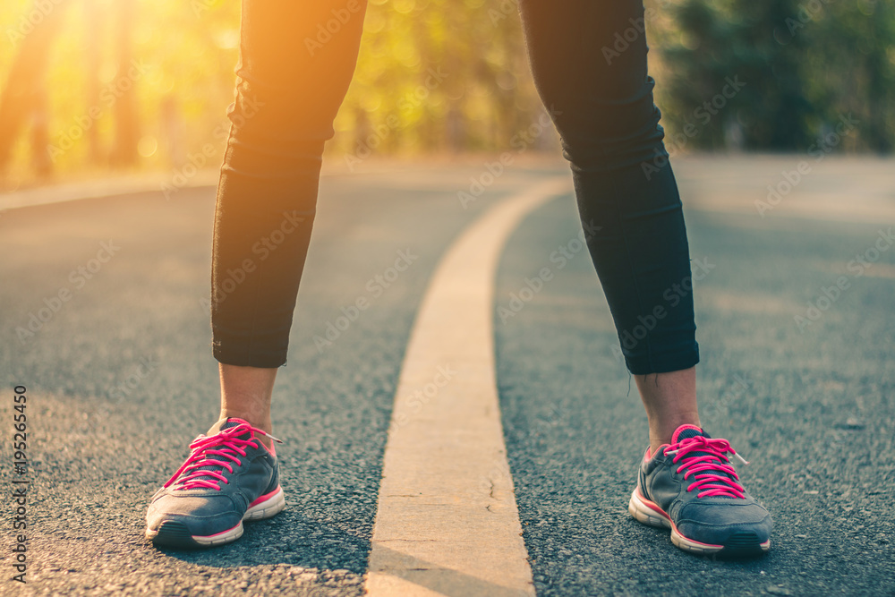 Women runner feet on road in workout wellness concept. Women runner feet on road in workout wellness concept.