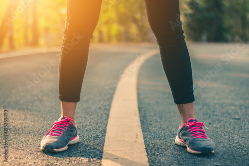 Women runner feet on road in workout wellness concept. © r_tee