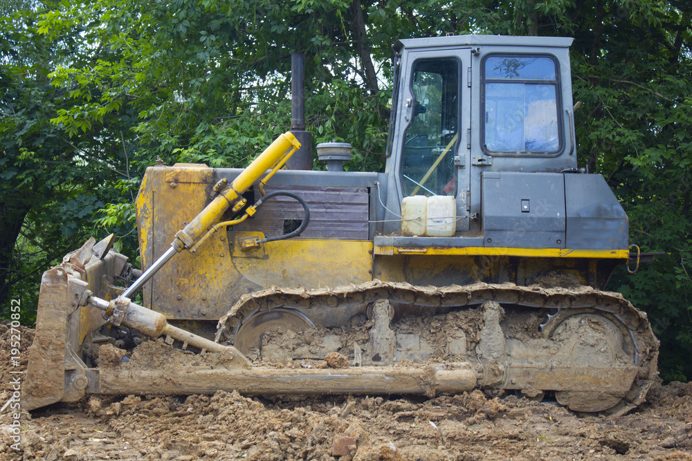 Bulldozer transports the ground.Construction excavator digging in the ground at the construction site.Slow motion shot.