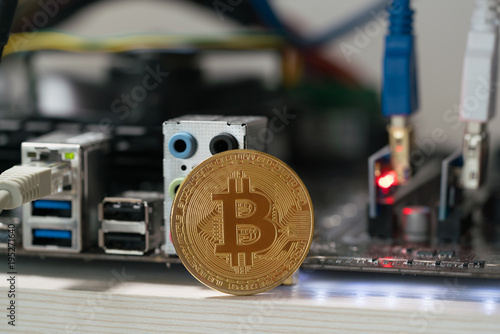 bitcoin against the background of the motherboard in the rack for the crypto currency mining photo