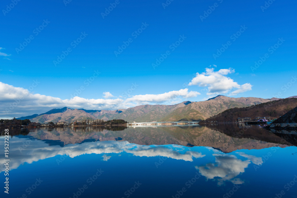 landscape river reflection view of bridge, mountain and traffic under blue sky, nature background
