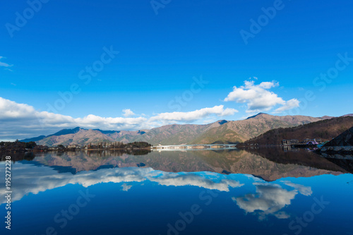 landscape river reflection view of bridge  mountain and traffic under blue sky  nature background
