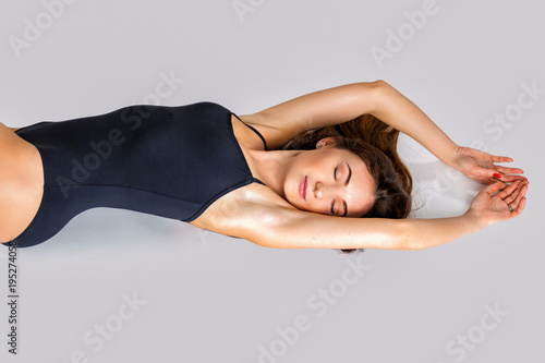 Portrait of a beautiful young woman in a black swimsuit