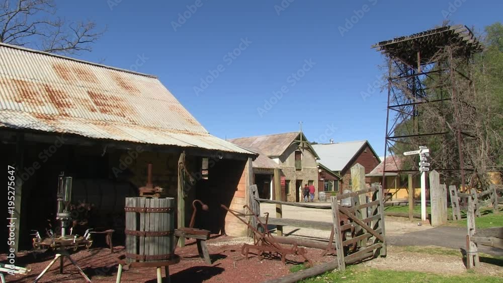 A steady shot of a ranch house with old equipment. A steady shot of a ranch house with old equipment.