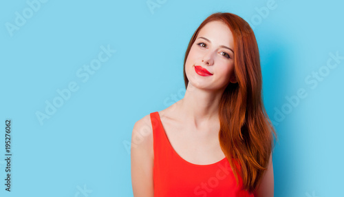 Young redhead girl in coral clothes