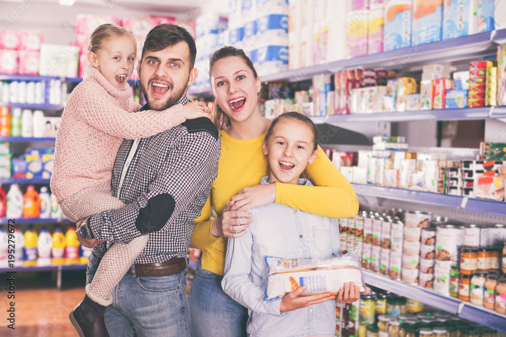 Portrait of family with daughters in food store