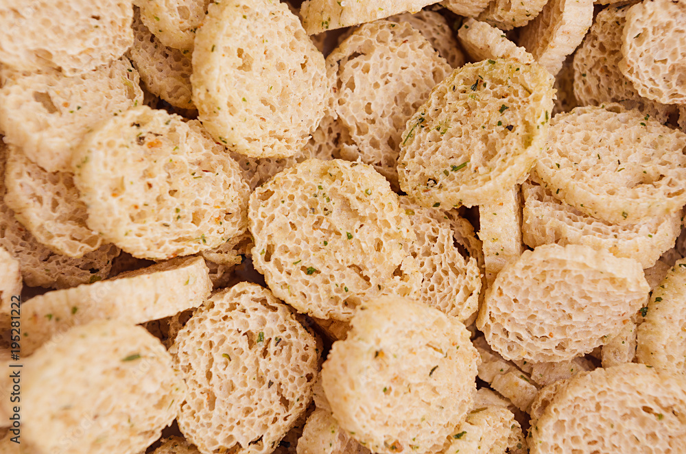Slices wheat beige croutons as background, top view, closeup. Slices wheat beige croutons as background, top view, closeup.