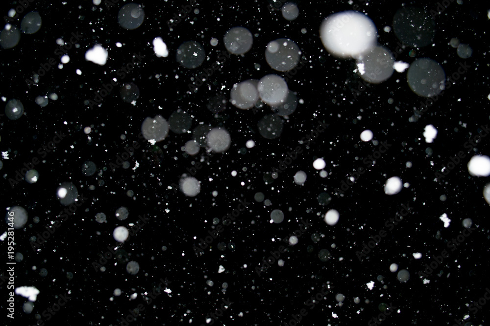 Photo of a dense snow falling at night, beautiful background