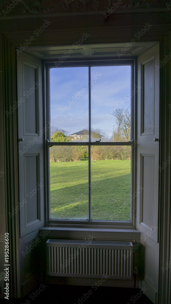 Fototapeta premium Look out of an old window in a vintage house