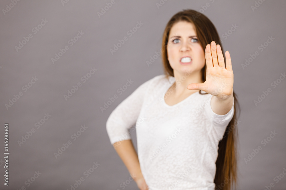 Angry apodicticity woman showing stop with hand Angry apodicticity woman showing stop with hand