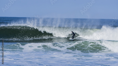 Guy surfing in winter on irish coast