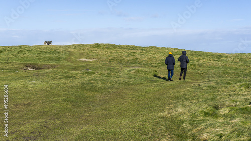 Two man walking on classic irish green fields © Ruben S.