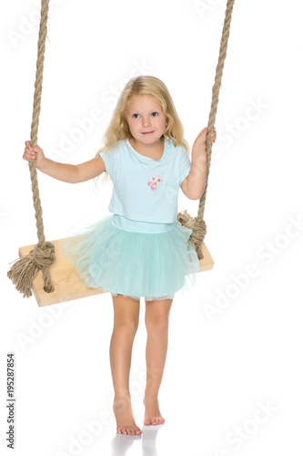 Little girl swinging on a swing