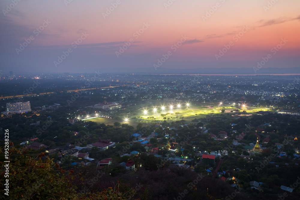 Fototapeta premium City of Mandalay in Myanmar (Burma), viewed from above from the Mandalay Hill in the evening.