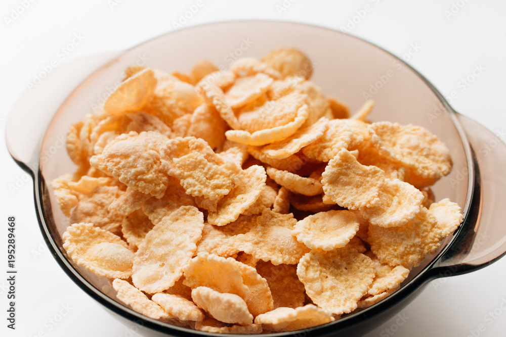 delicious crispy cornflakes in bowl on white background, healthy breakfast delicious crispy cornflakes in bowl on white background, healthy breakfast