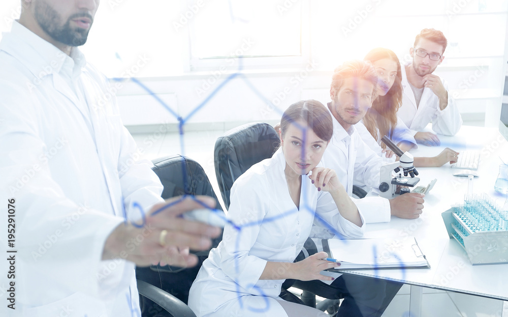 Obraz premium from behind the glass. a scientist standing near the blackboard 