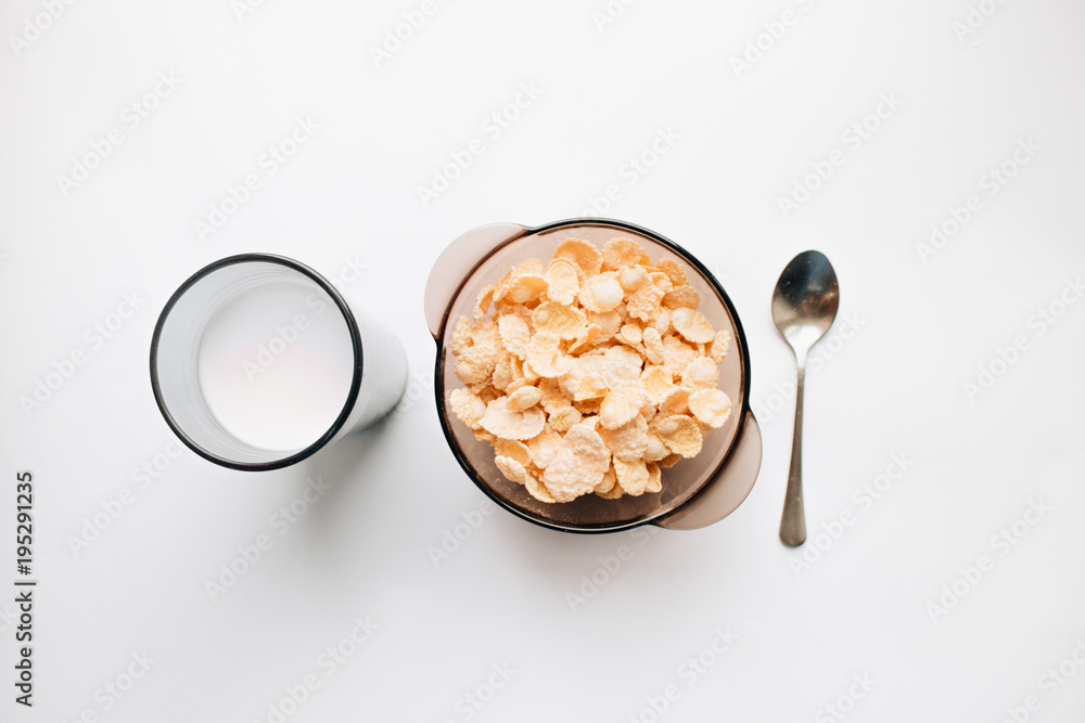 Delicious crispy cornflakes in bowl on white background, healthy breakfast Delicious crispy cornflakes in bowl on white background, healthy breakfast