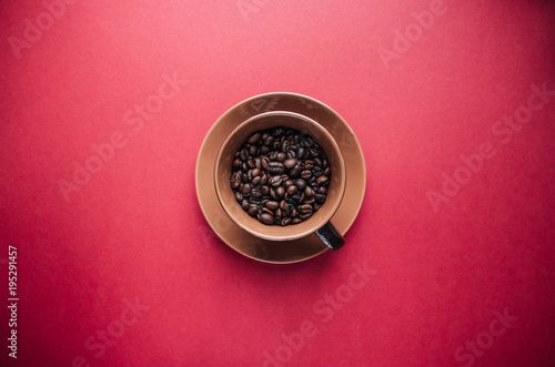 cup of black coffee and coffee beans on dark background 