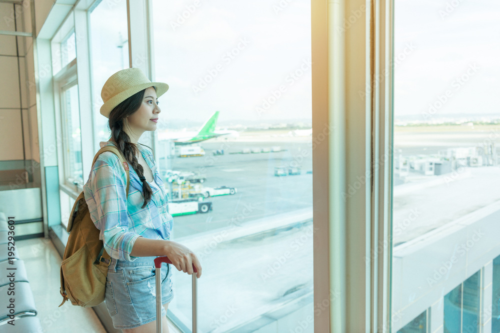 travel woman looking at window in airport