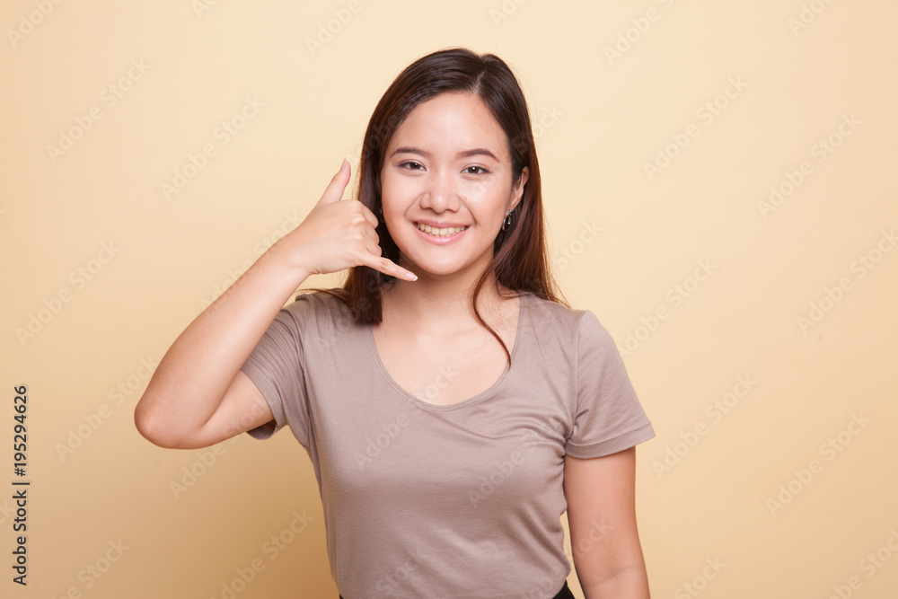 Young Asian woman show with phone gesture. Young Asian woman show with phone gesture.