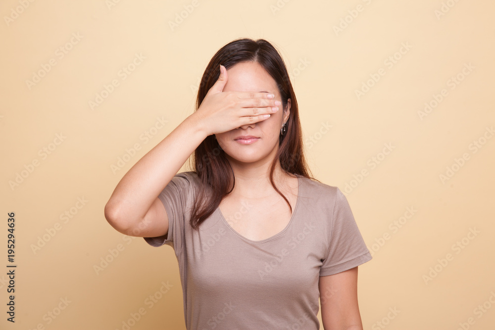 Young Asian woman close her eyes with hand. Young Asian woman close her eyes with hand.